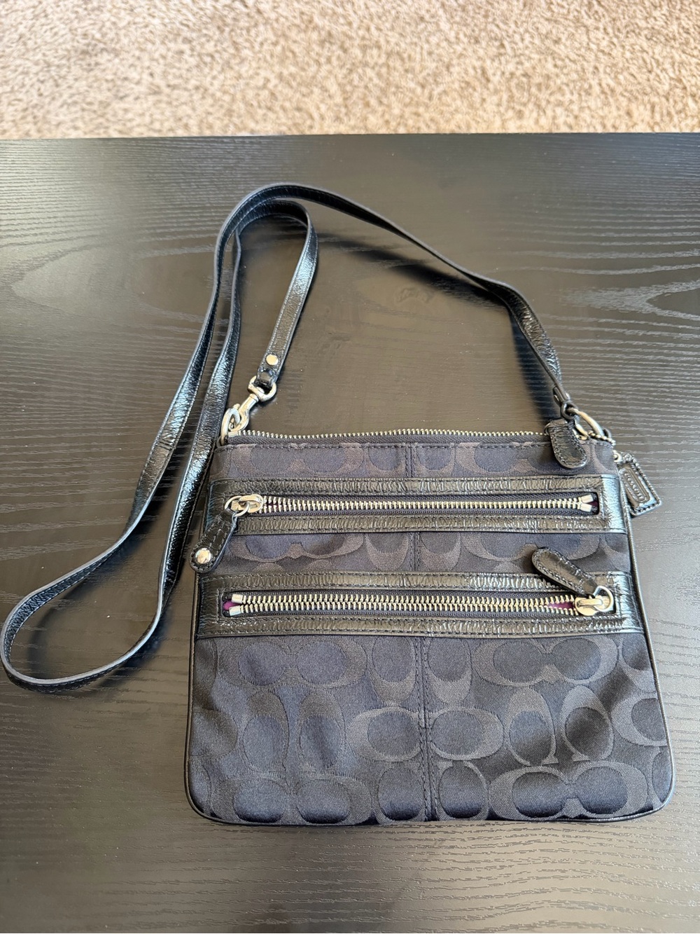 Coach Poppy Swing Pack Black Crossbody Bag with Signature Pattern.